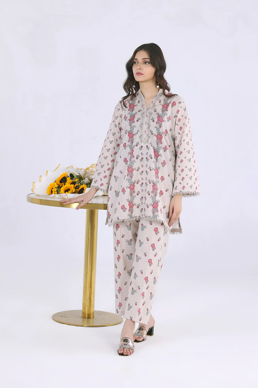 Woman wearing a cream floral 2-piece cotton lawn suit with lace detailing
