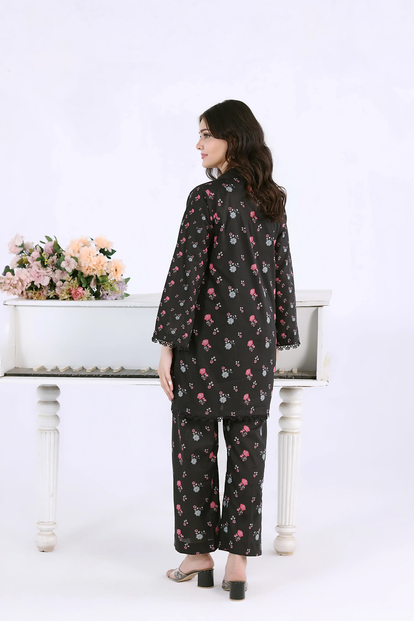Side-back view of the black co-ord set showing the straight silhouette and matching printed trousers.